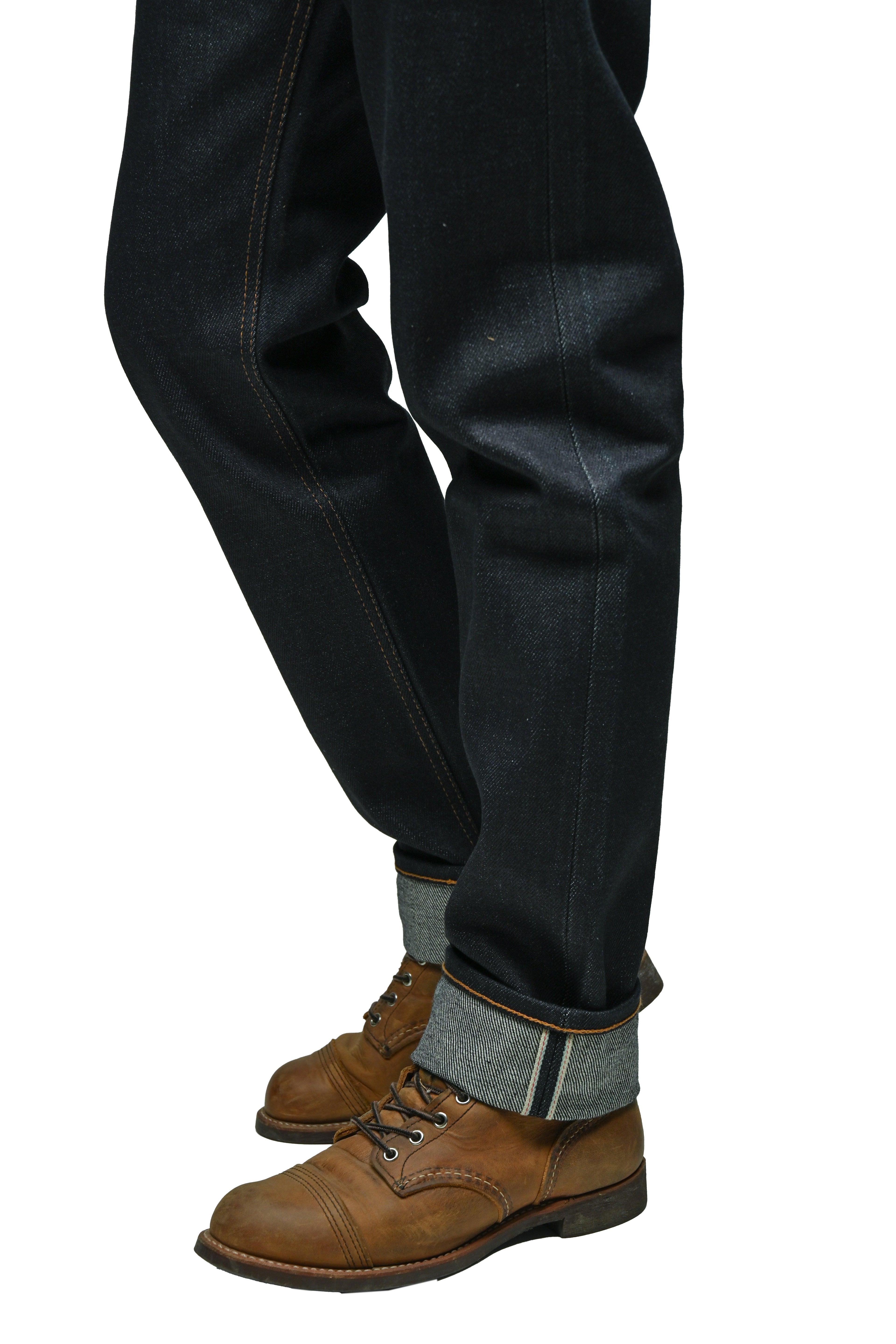 Mith Denim 23oz Japanese selvedge denim jeans with cuffed hem showing selvedge ID stripe, worn with brown leather boots