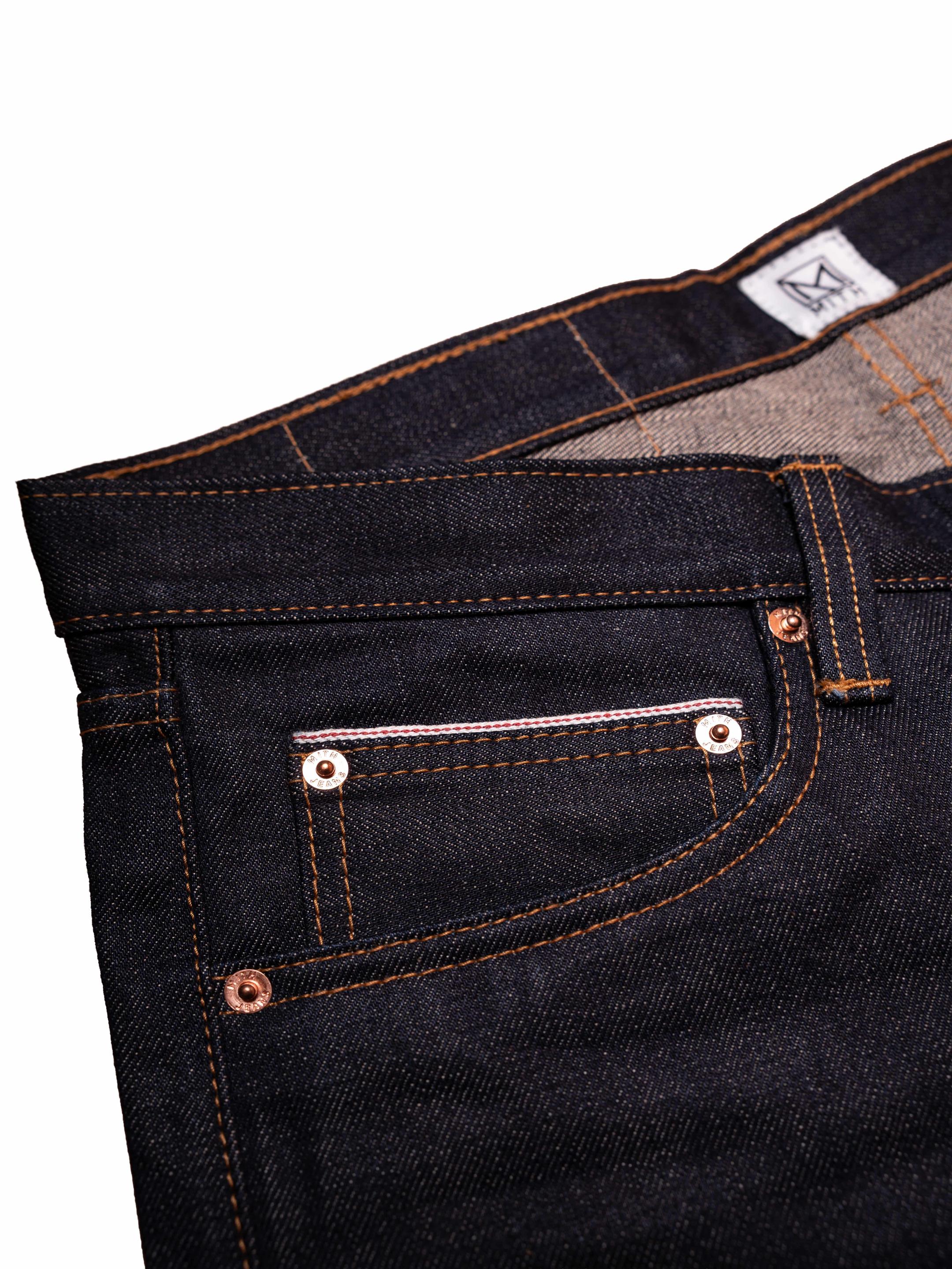 Close-up of 16 oz japanese selvedge denim with stitching details on a white background